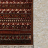 Raktambar – Hand Knotted Wool Rug in Maroon/Orange Rust