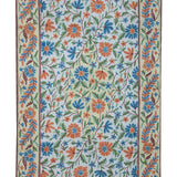 Gulmarg handmade floral rug with chain stitch embroidery in cream and light blue, featuring vibrant orange and blue flowers with green leaves on a soft cotton base.