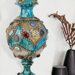 Ornate azure Surahi vase crafted from camel bone with intricate gold-toned metalwork and colorful semi-precious stone embellishments.