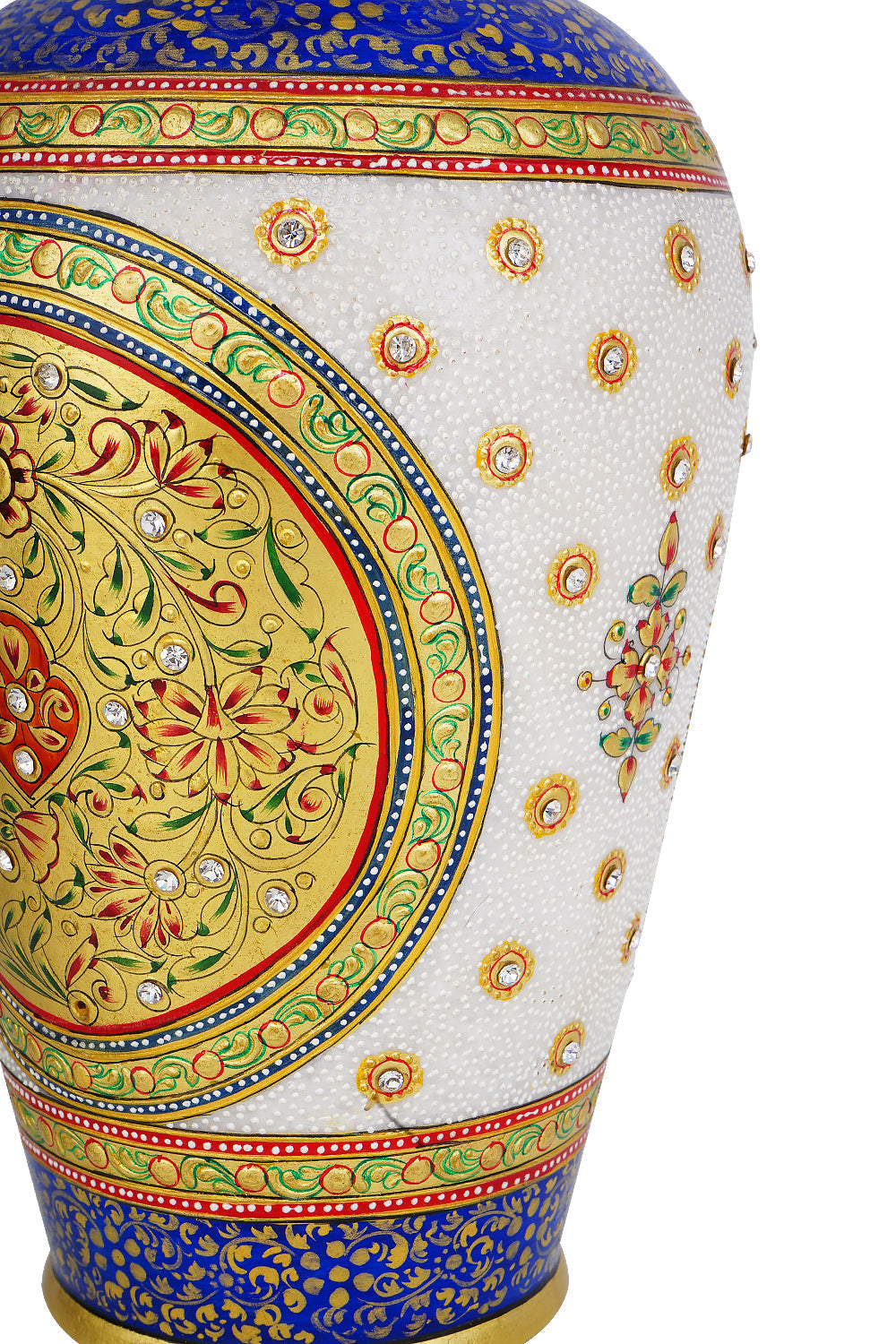 Close-up view of a white marble vase showcasing intricate hand-painted floral and geometric designs in rich blues, reds, and greens, heavily accented with gold and embedded with small, clear gemstones. The detail highlights the craftsmanship of the painting and the jewel-like embellishments.