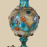 Disassembled azure Surahi vase made of camel bone, showing the main body and the separate, intricately decorated lid with metal and gemstone inlays.