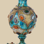 Disassembled azure Surahi vase made of camel bone, showing the main body and the separate, intricately decorated lid with metal and gemstone inlays.