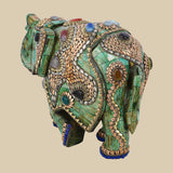 Embellished green elephant art piece crafted from camel bone, featuring detailed gold-colored metalwork and various colorful gemstone inlays.