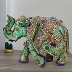 Handmade green camel bone elephant sculpture intricately adorned with gold metalwork and colorful gemstone inlays.
