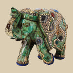 Intricately jeweled green elephant decor crafted from camel bone with detailed gold-tone metalwork and colorful semi-precious stone accents.