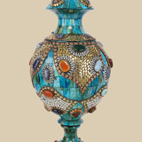 Lidded azure Surahi vase crafted from camel bone featuring intricate gold-toned metalwork and colorful semi-precious stone accents.