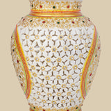 White marble vase featuring intricate openwork undercut carving, hand-painted with gold accents and embellished with embedded red and green gemstones, showcasing a delicate lattice design.