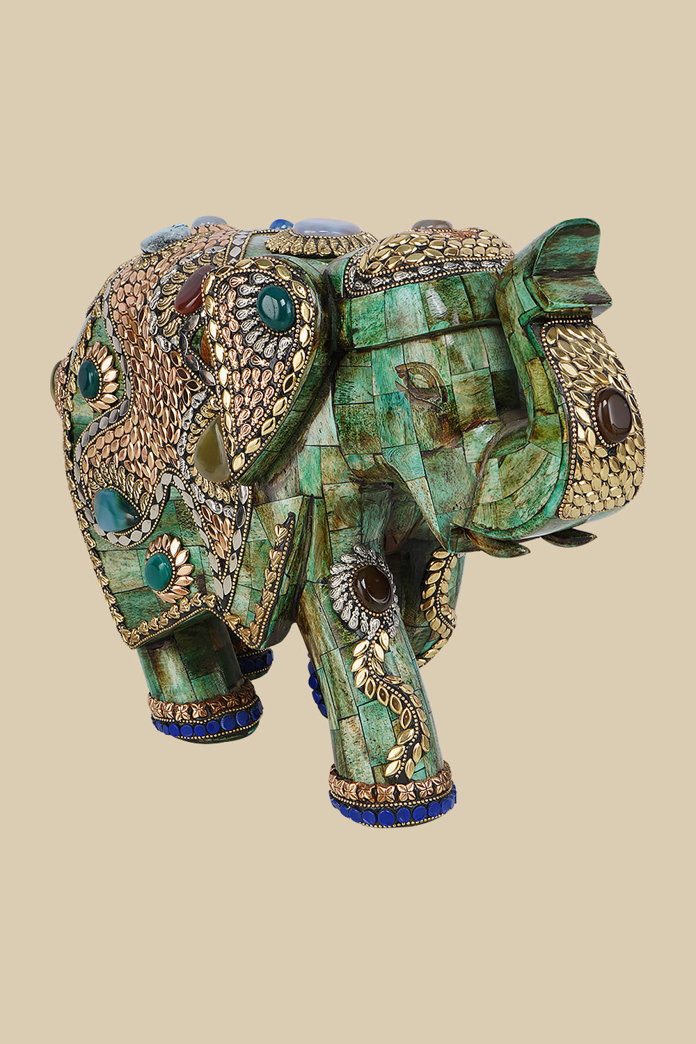 Ornate green camel bone elephant figurine featuring intricate gold-colored metalwork and various semi-precious stone embellishments.
