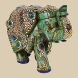 Ornate green camel bone elephant figurine featuring intricate gold-colored metalwork and various semi-precious stone embellishments.