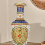 Ornate white marble flower vase meticulously hand-painted with traditional Indian motifs in vibrant blue, red, and green, highlighted with gold accents and small embedded gemstones.