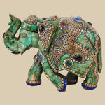 Regal green camel bone elephant sculpture intricately decorated with gold-toned metalwork and colorful gemstone inlays, showcasing traditional Indian craftsmanship