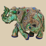 Regal green camel bone elephant sculpture intricately decorated with gold-toned metalwork and colorful gemstone inlays, showcasing traditional Indian craftsmanship
