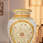 Elegant white marble vase with intricate undercut detailing, hand-painted with colorful floral patterns, accented with gold highlights and embedded red and green stonework.