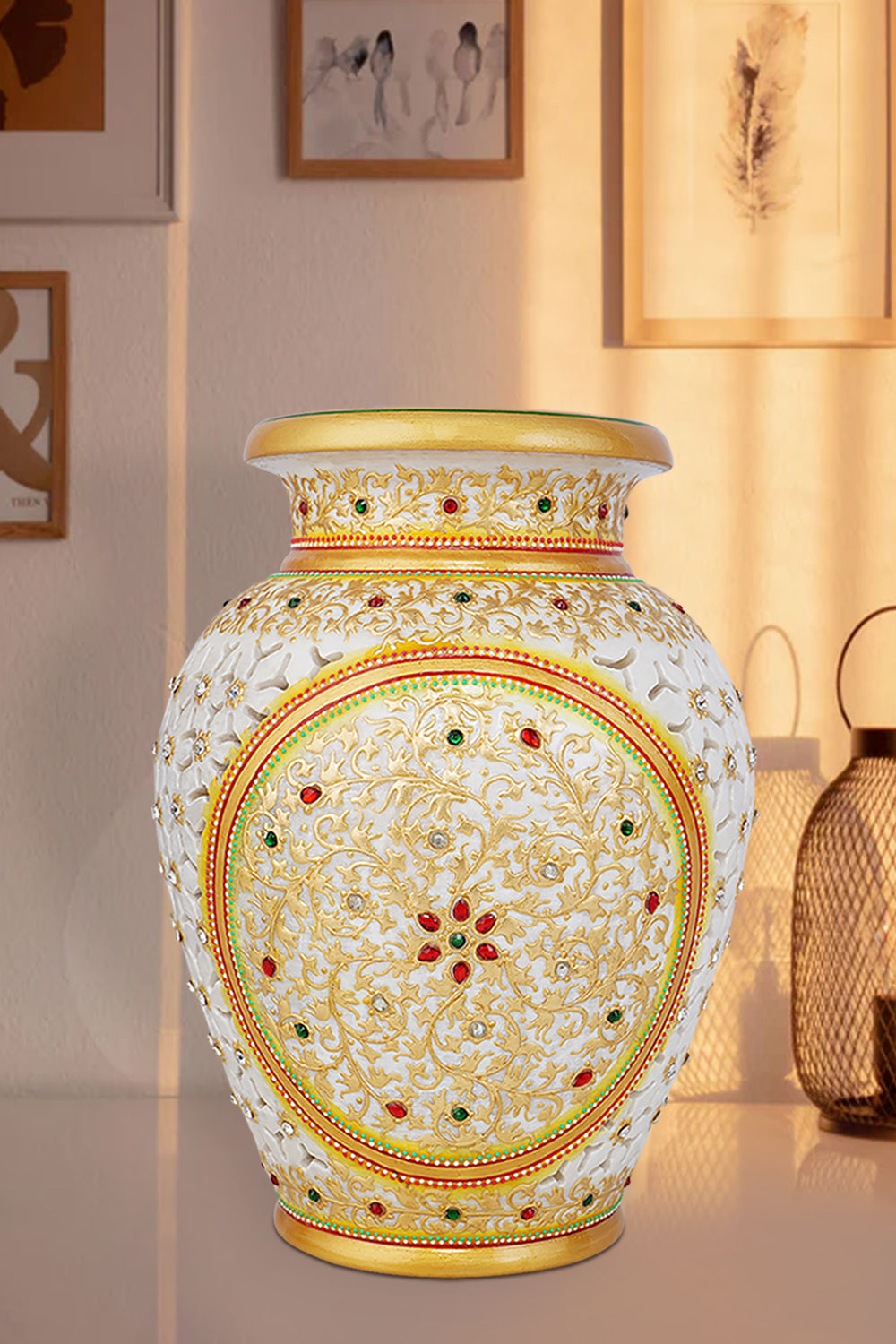 Elegant white marble vase with intricate undercut detailing, hand-painted with colorful floral patterns, accented with gold highlights and embedded red and green stonework.