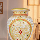 Elegant white marble vase with intricate undercut detailing, hand-painted with colorful floral patterns, accented with gold highlights and embedded red and green stonework.